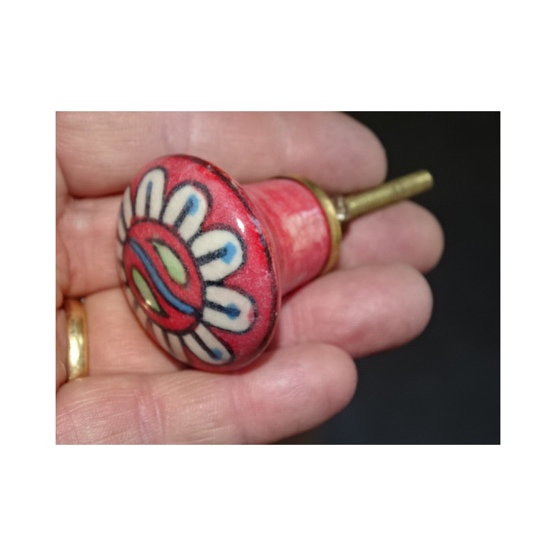 red pear shaped button and white flower