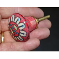 red pear shaped button and white flower