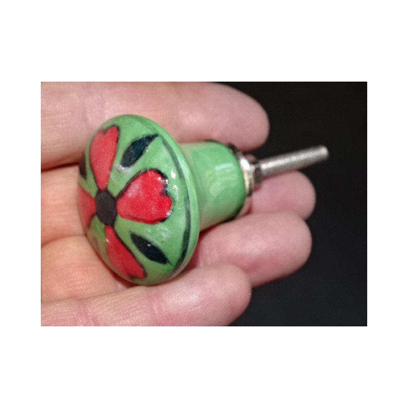 green pear shaped button and red flower