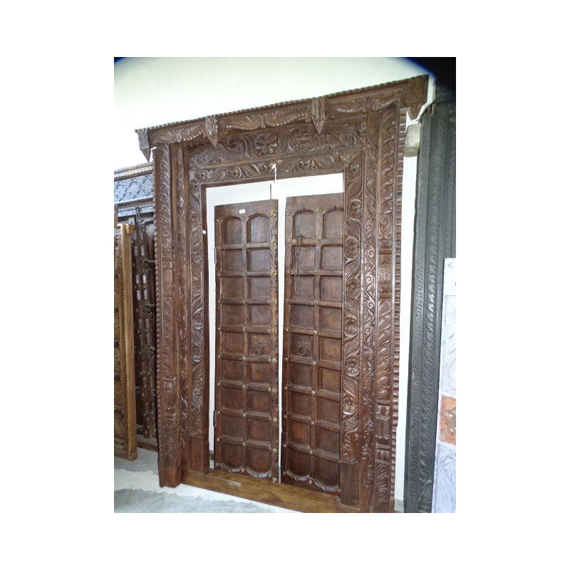 Old doors decorated with a carved lintel...