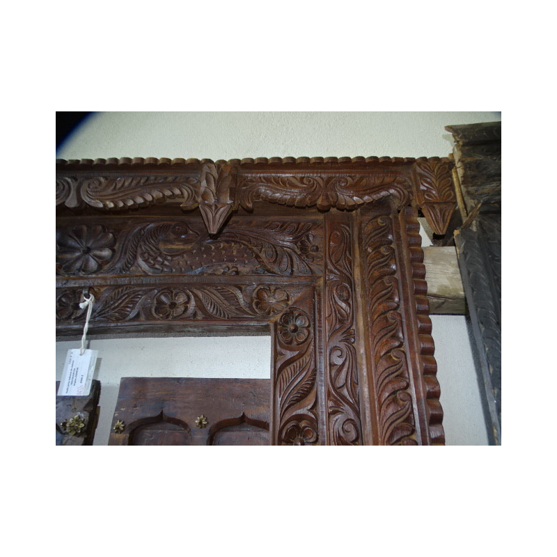 Old doors decorated with a carved lintel...
