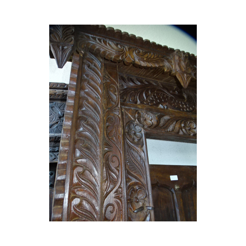 Old doors decorated with a carved lintel...