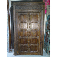 Patinated house door in dark