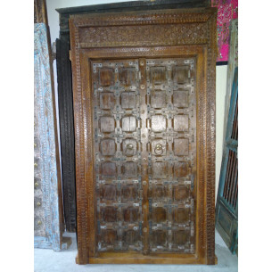Patinated house door in dark with steel fittings