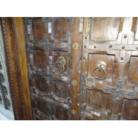 Patinated house door in dark with steel fittings