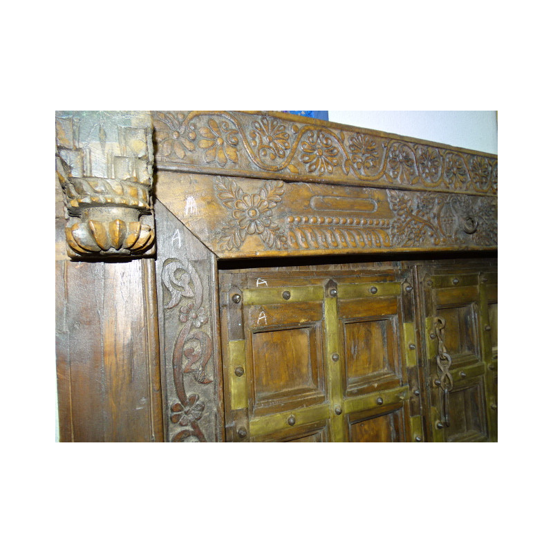 Very old low door of Indian house with coat hook