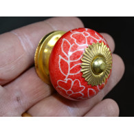 Red porcelain drawer handle and white flowers